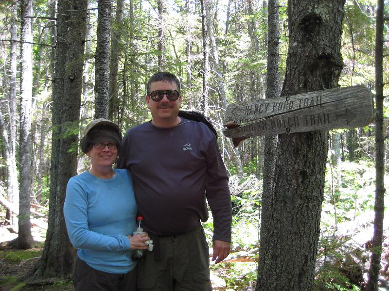 PemiTraverse (15).JPG - Kathy and Brian deep in the forest. Note the bug screen on Kathy's head. We fought our way through hordes of mosquitoes in Carrigan Notch.
